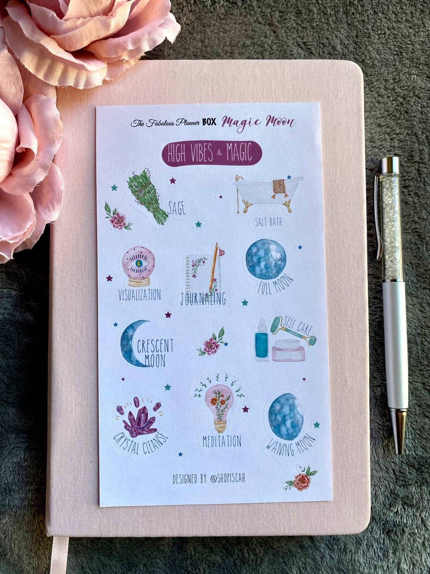 Single 4x6 inch Magic Moon planner sticker sheet featuring crescent moons, affirmation phrases, crystals, and celestial illustrations arranged on a notebook with a pen — for Carpe Diem Dream
