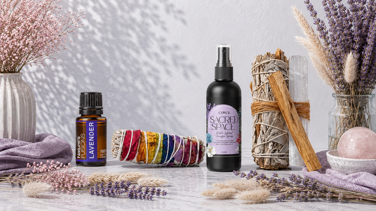Essential oils, smudge, and sprays collection featuring lavender essential oil, a chakra rose petal sage bundle, sacred space spray, and an energy-clearing sage, palo santo, and selenite bundle in a bright botanical setting. — for Carpe Diem Dream