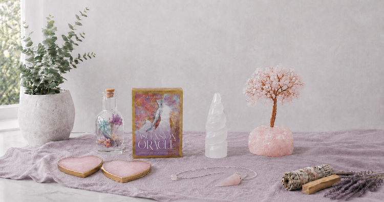 Metaphysical and mystical collection with oracle cards, rose quartz tree, selenite tower, heart-shaped coasters, pendulum, floral candle, and cleansing bundle — for Carpe Diem Dream