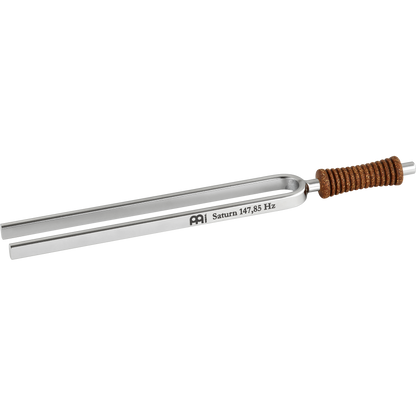 Single metal tuning fork with cork handle engraved Saturn 147.85 Hz shown on a white background. — for Carpe Diem Dream