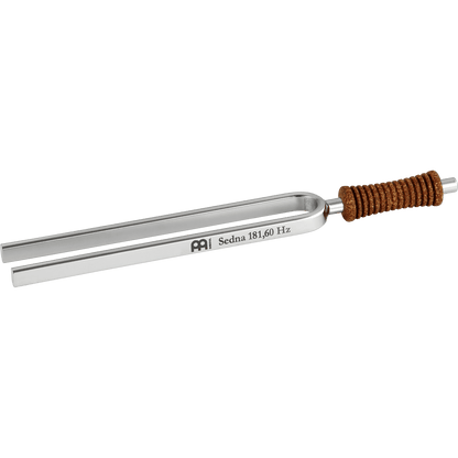 Single metal tuning fork with cork handle engraved Sedna 181.60 Hz shown on a transparent background. — for Carpe Diem Dream