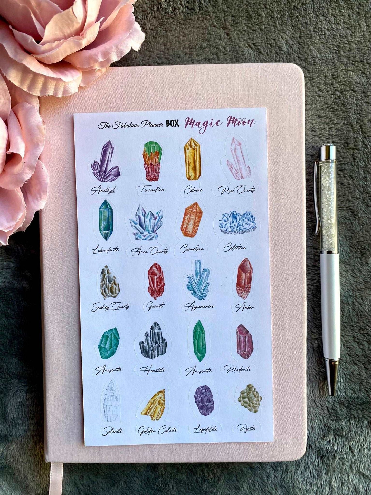 Single 4x6 inch Magic Moon planner sticker sheet featuring illustrated crystal designs labeled with their names on a dark textured surface — for Carpe Diem Dream