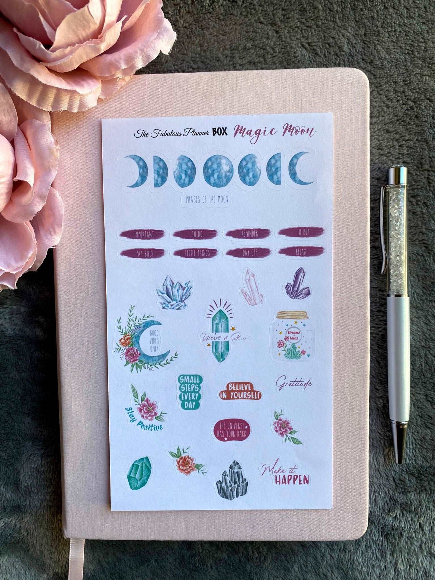 Single 4x6 inch Magic Moon planner sticker sheet featuring moon phases, celestial icons, and decorative labels arranged on a notebook with a pen — for Carpe Diem Dream