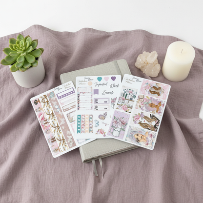 Three Miss Butterfly 4x6 planner sticker sheets arranged on mauve fabric with a notebook, candle, crystal cluster, and small succulent. — for Carpe Diem Dream