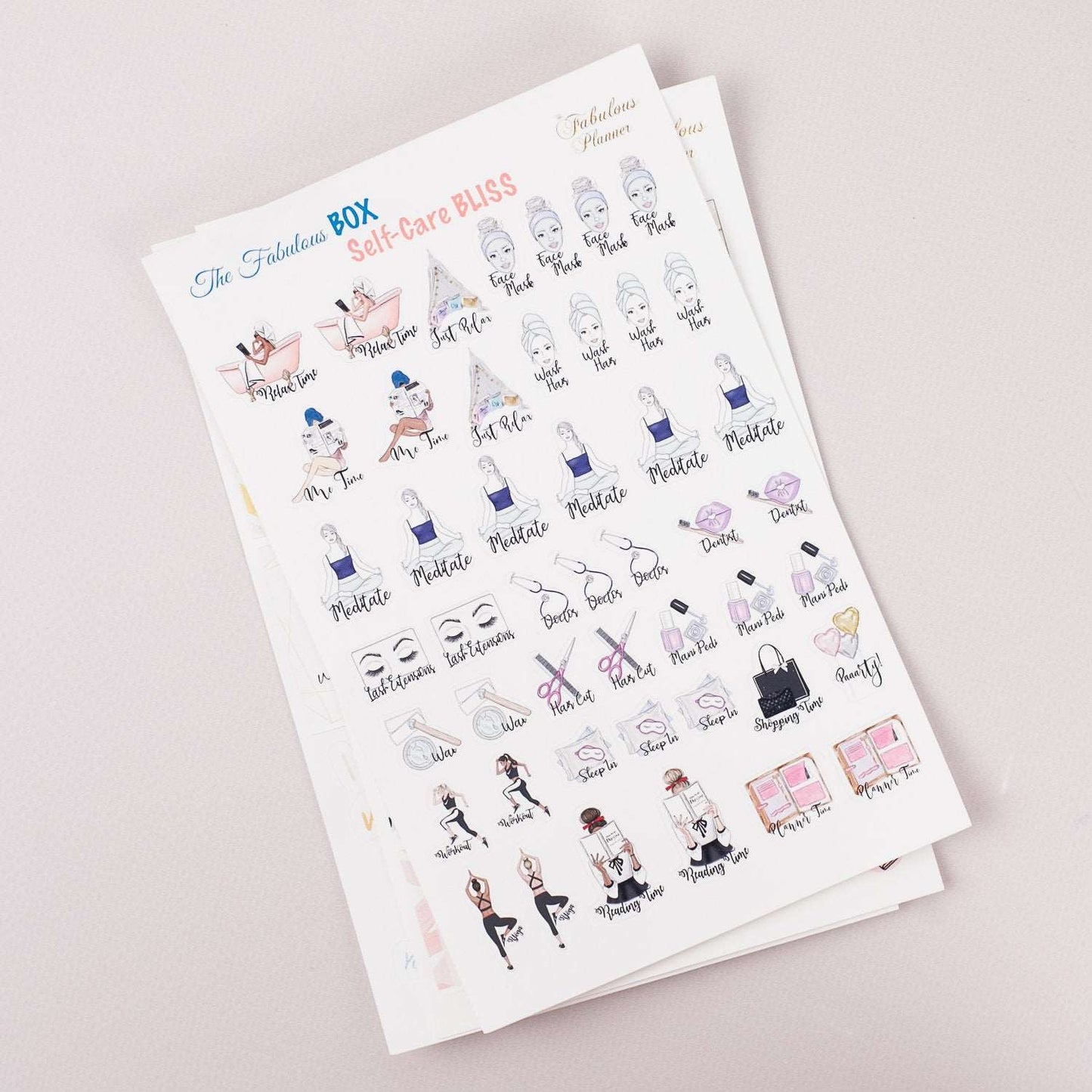 Angled view of three 4x6 inch self care planner sticker sheets stacked together displaying illustrated wellness icons and motivational text on a light background. — for Carpe Diem Dream