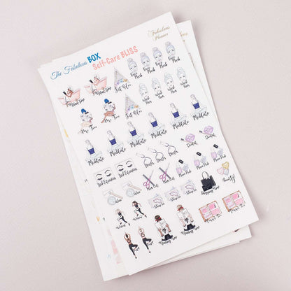 Angled view of three 4x6 inch self care planner sticker sheets stacked together displaying illustrated wellness icons and motivational text on a light background. — for Carpe Diem Dream
