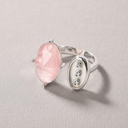 Rose quartz and silver angel number 333 ring displayed on a soft neutral fabric backdrop. — for Carpe Diem Dream