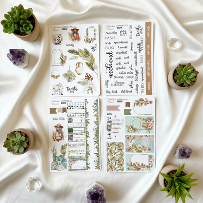 Four 4x6 boho chic happy planner matte sticker sheets arranged on soft satin fabric with small succulents and crystal accents. — for Carpe Diem Dream