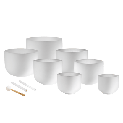 Seven white frosted crystal singing bowls in sizes 14 inch through 8 inch with three mallets and silicone rings displayed on a transparent background — for Carpe Diem Dream