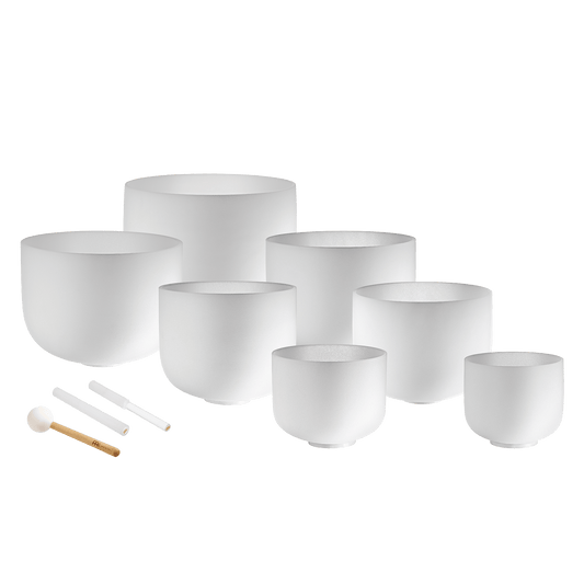 Seven white frosted crystal singing bowls in sizes 14 inch through 8 inch with three mallets and silicone rings displayed on a transparent background — for Carpe Diem Dream