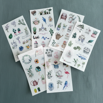 Six 4x6 clear boho plant planner sticker sheets fanned out on a textured green fabric background. — for Carpe Diem Dream