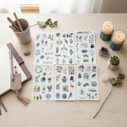 Six 4x6 clear boho plant planner sticker sheets arranged on a light wood desk with lit candles, a purple crystal cluster, a small succulent, and journaling accessories. — for Carpe Diem Dream