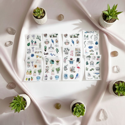 Six 4x6 clear boho plant planner sticker sheets arranged on soft satin fabric with small succulents and decorative stones in natural light. — for Carpe Diem Dream