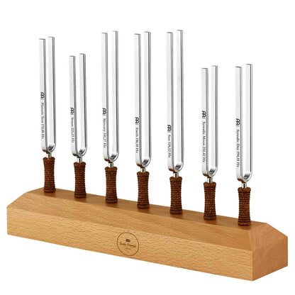 Seven chakra tuning forks with cork handles mounted upright on a wooden display base. — for Carpe Diem Dream