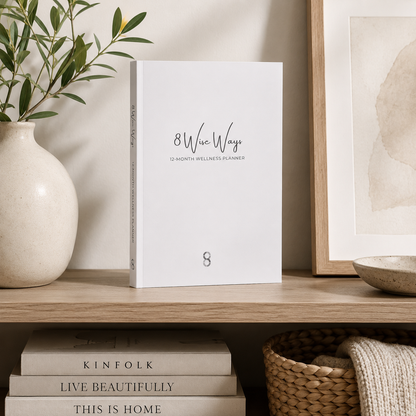 8 Wise Ways 12-Month Wellness Planner displayed in a calm home sanctuary with natural textures and mindful décor that support wellbeing, reflection, and intentional living. — for Carpe Diem Dream