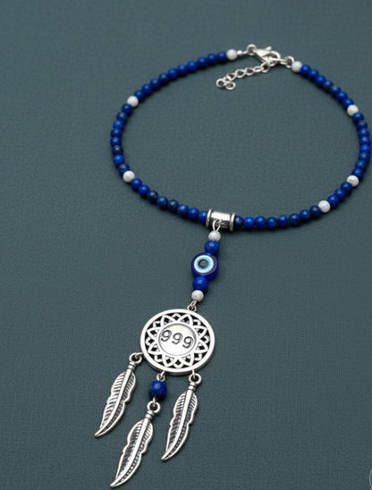 Silver dream catcher necklace with 999 angel number pendant and blue gemstone beaded chain displayed on soft sage background. — for Carpe Diem Dream
