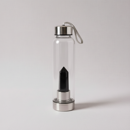 A clear glass crystal-infused water bottle with a sleek black obsidian point enclosed in the stainless steel crystal chamber. — for Carpe Diem Dream