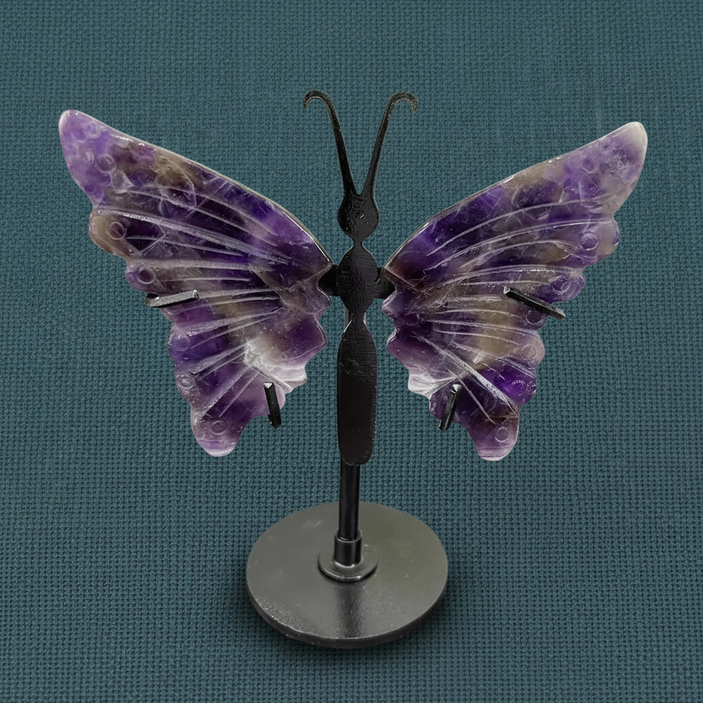 Amethyst crystal butterfly wings on a black stand displayed upright on a deep teal linen background with soft diffused lighting. — for Carpe Diem Dream
