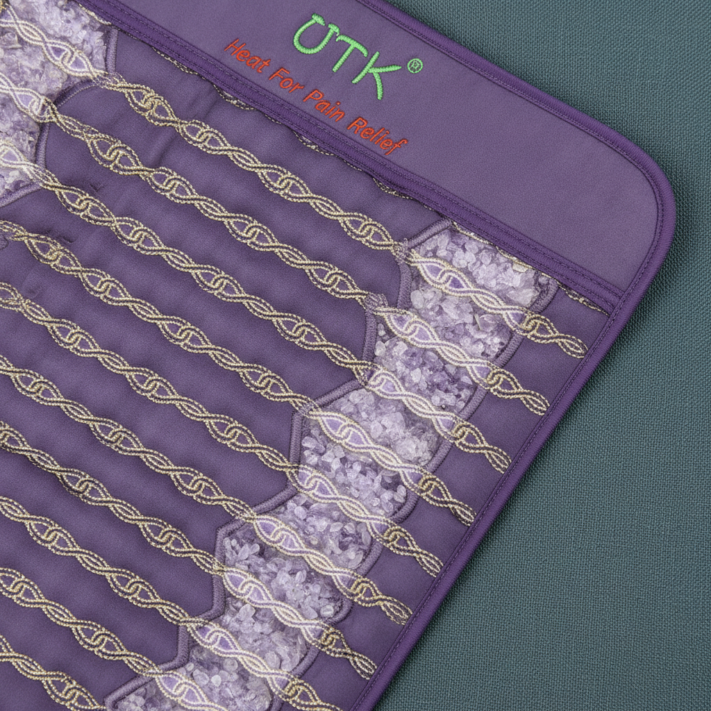 Close-up view of amethyst crystal stones embedded inside a far infrared heating pad with stitched heating channels. — for Carpe Diem Dream