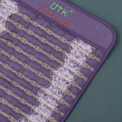 Close-up view of amethyst crystal stones embedded inside a far infrared heating pad with stitched heating channels. — for Carpe Diem Dream