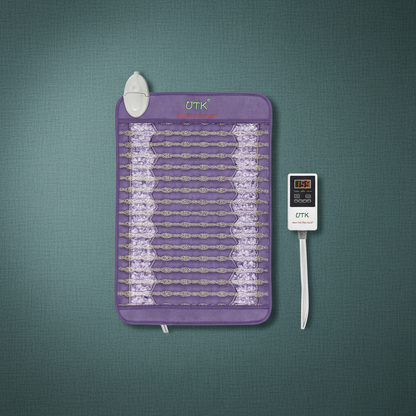 Amethyst far infrared heating pad with embedded crystal stones and digital temperature controller displayed on a teal surface. — for Carpe Diem Dream