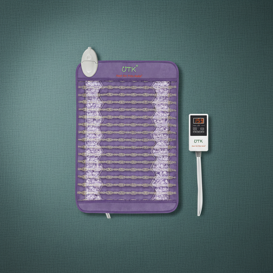 Amethyst far infrared heating pad with embedded crystal stones and digital temperature controller displayed on a teal surface. — for Carpe Diem Dream