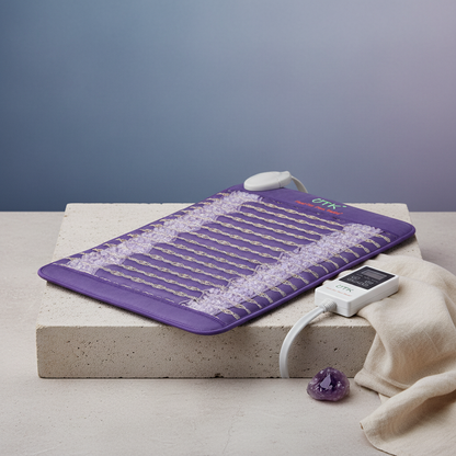 Amethyst far infrared heating pad with embedded crystal stones and digital temperature controller displayed on a stone platform. — for Carpe Diem Dream