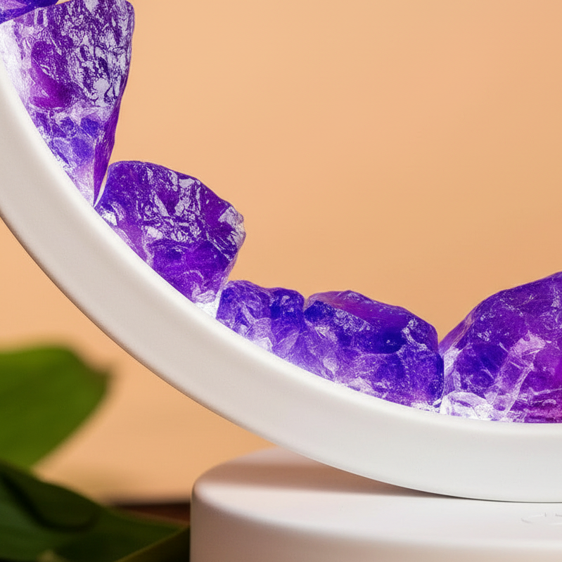 Close-up of amethyst halo lamp showing natural purple crystals set inside circular frame against soft peach backdrop. — for Carpe Diem Dream