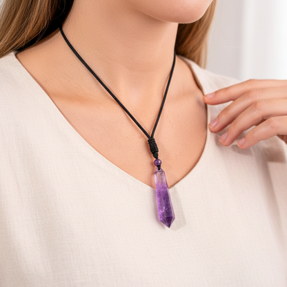 Amethyst crystal pendant worn on a black cord resting naturally against a cream blouse, showcasing its true scale and soft bedroom light. — for Carpe Diem Dream