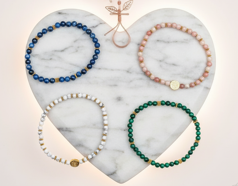 Multicolored love bracelets arranged in a circle on a white marble heart tray. — for Carpe Diem Dream