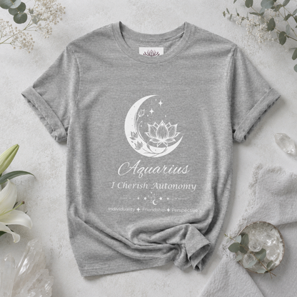 Aquarius Moon I Cherish Autonomy zodiac T-shirt in Athletic Heather with white moon-inspired lotus, floral, and celestial artwork and Individuality, Friendship, Perspective text, styled in a cool-toned studio botanical flat lay. — for Carpe Diem Dream