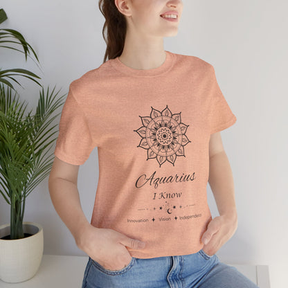 Aquarius Sun I Know zodiac T-shirt in heather peach with black sun-inspired mandala artwork, shown worn by a model in a supplier mockup. — for Carpe Diem Dream