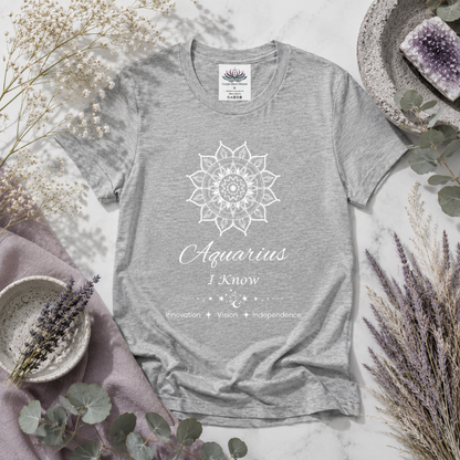 Aquarius Sun I Know zodiac T-shirt in athletic heather with white sun-inspired mandala artwork and Innovation, Vision, Independence text, styled in a cool-toned studio botanical flat lay. — for Carpe Diem Dream