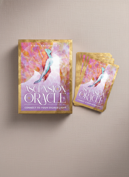 Ascension Oracle deck displayed on a soft neutral background with its cover and cards partially fanned, showcasing luminous pastel artwork – for Carpe Diem Dream.