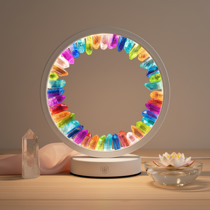A rainbow-aura clear quartz halo lamp glowing beside a rose quartz point and a floating lotus candle on a natural wood surface. — for Carpe Diem Dream
