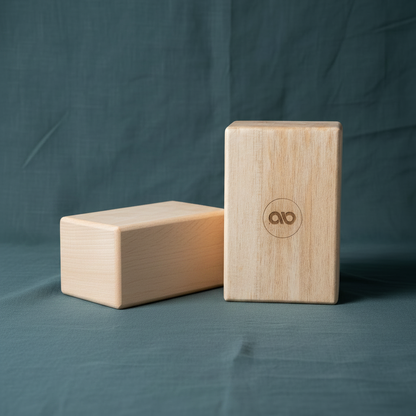 Two natural balsa wood yoga blocks displayed on a teal fabric background with one block standing upright and one block lying horizontally. — for Carpe Diem Dream