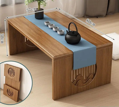 A bamboo folding table in an 80cm size displayed on a wooden floor with a tea setup, highlighting its balanced proportions and natural finish. — for Carpe Diem Dream