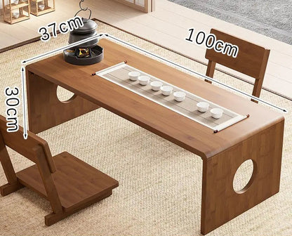 A bamboo folding table in 100cm size displayed in a natural interior setting with a tea setup, showing its larger surface area and low-profile design. — for Carpe Diem Dream