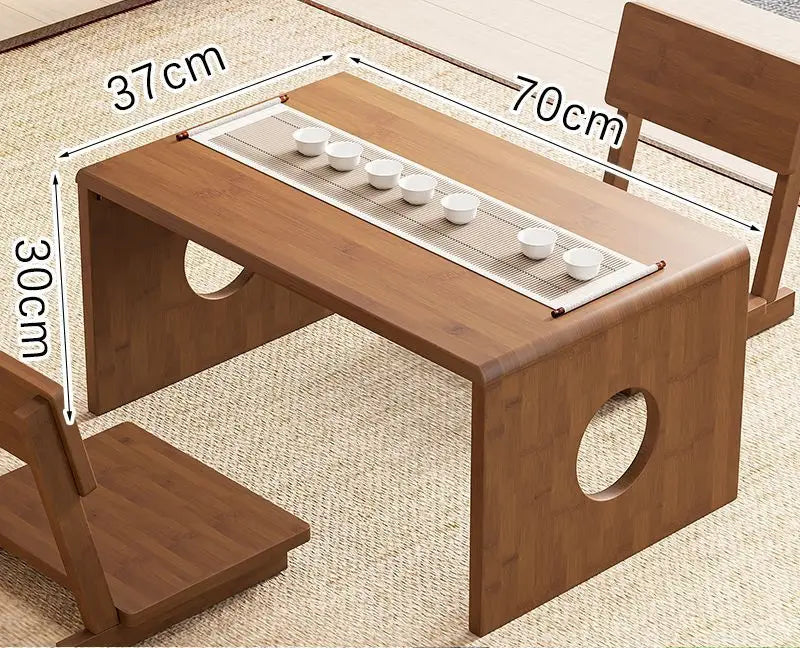 A bamboo folding table in 70cm size displayed in a natural interior setting with a tea setup, showing its compact surface and low-profile design. — for Carpe Diem Dream