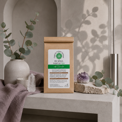 Be Well Immuni-Tea – Organic Crystal-Infused Tea with Fluorite displayed in the Carpe Diem Dream signature botanical studio with Roman Clay walls, cool greige styling, eucalyptus, natural stone, matte ceramics, mauve linen, botanical shadows, and cool diffused daylight. — for Carpe Diem Dream