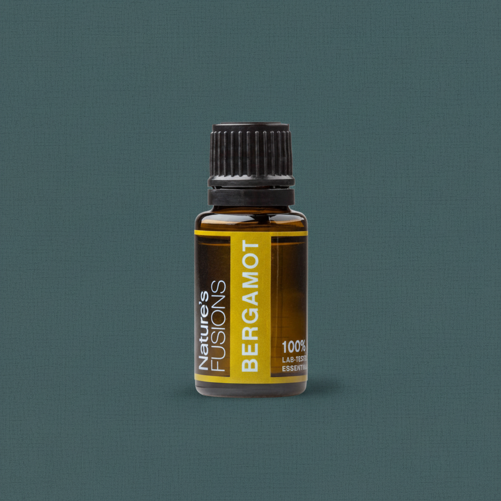 A 15ml amber glass bottle of Bergamot essential oil with a black ribbed cap and yellow label displayed upright on a muted teal background. — for Carpe Diem Dream