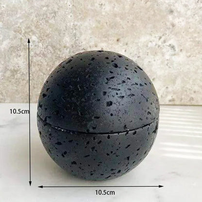A black travertine sphere incense burner displayed with size dimensions on a white background showing natural stone variation. — for Carpe Diem Dream
