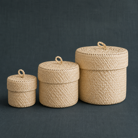 Blonde small storage basket set of three handmade pandanus leaf baskets on a dark teal linen backdrop. — for Carpe Diem Dream