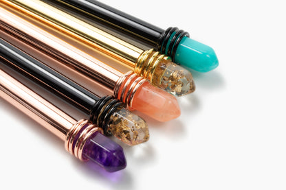 Close-up of metallic Busy Manifesting crystal mystic pens showing faux crystal tops and engraved detailing. — for Carpe Diem Dream