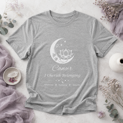 Cancer Moon I Cherish Belonging zodiac T-shirt in Athletic Heather with white moon-inspired lotus, floral, and celestial artwork and Sensitivity, Nurturing, Security text, styled in a cool-toned studio botanical flat lay. — for Carpe Diem Dream