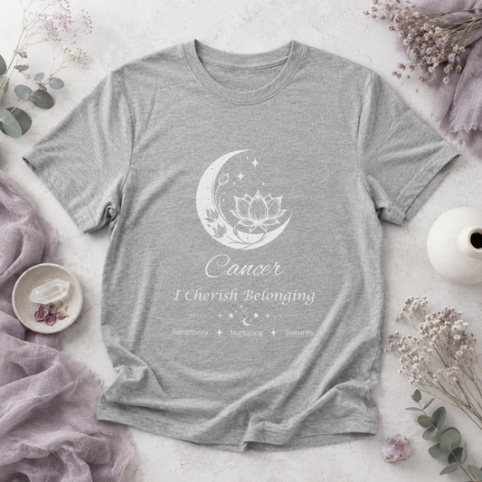 Cancer Moon I Cherish Belonging zodiac T-shirt in Athletic Heather with white moon-inspired lotus, floral, and celestial artwork and Sensitivity, Nurturing, Security text, styled in a cool-toned studio botanical flat lay. — for Carpe Diem Dream