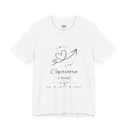 White Capricorn Rising I Build zodiac T-shirt with black celestial heart and arrow artwork, shown in a flat supplier mockup. — for Carpe Diem Dream