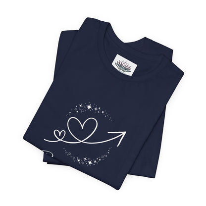 Capricorn Rising I Build zodiac T-shirt in navy with white celestial heart and arrow artwork, shown folded in a supplier mockup. — for Carpe Diem Dream