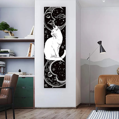 Black and white cat moon celestial banner tapestry displayed vertically on a living room wall beside a chair and shelving, showing full length and real placement in a modern interior space. — for Carpe Diem Dream