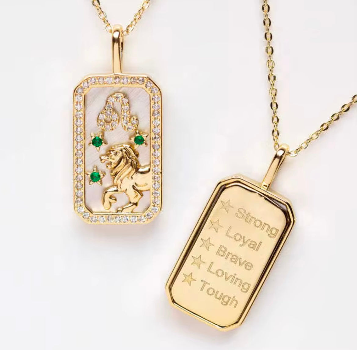 An 18K gold Leo zodiac pendant necklace with lion constellation detailing and engraved affirmation text displayed on a white background. — for Carpe Diem Dream